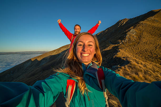 istock Hikers on mountain ridge take selfie portrait 616240242
