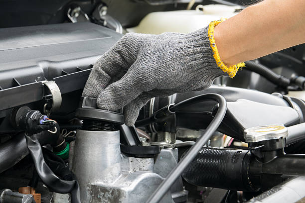 istock mechanic is opening the oil cap from a car engine. 616247644