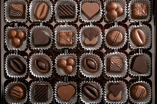 elevated view of close up fresh chocolates in box.