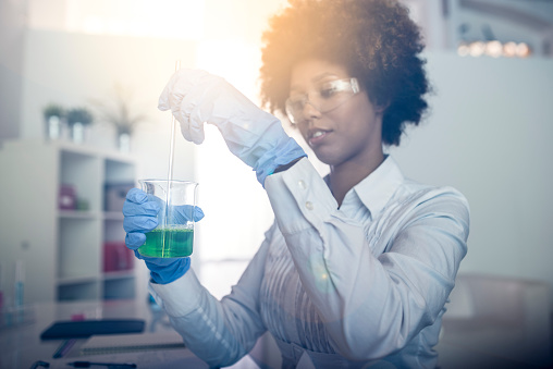 A young African American woman doing experiments in the laboratory