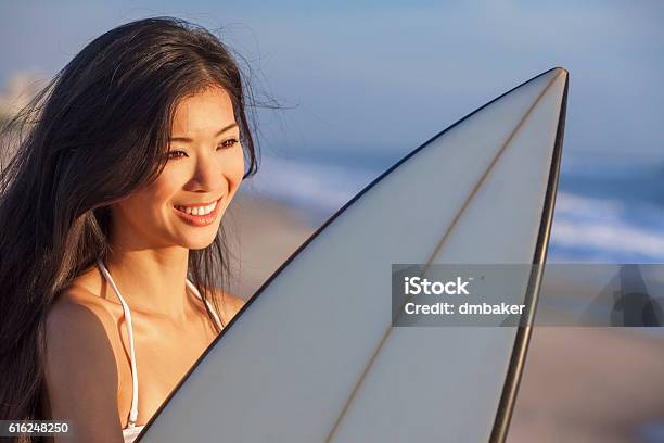 Woman Bikini Surfer Surfboard Sunset Sunrise Beach Stock Photo - Download Image Now
