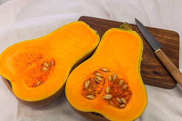 istock Squash cut in half on a wooden board 616248350