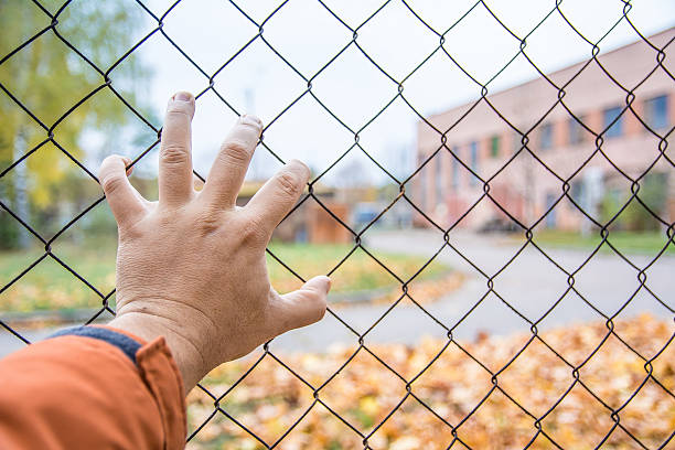 hand on a fence, there is no way, chernobyl - cyclone fence imagens e fotografias de stock