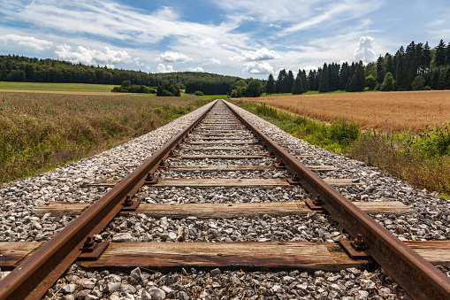 railway tracks in a rural scenery.