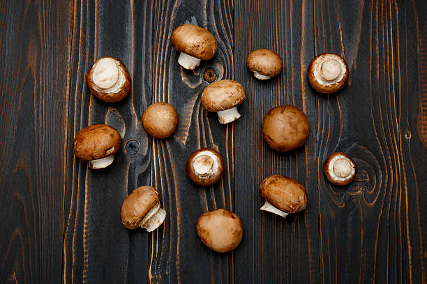 istock champignon mushroom on wooden background 616255402