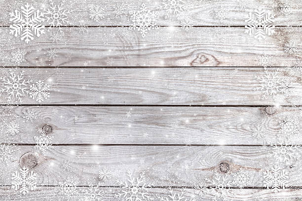 istock Snowflakes on a wooden background. 616255684