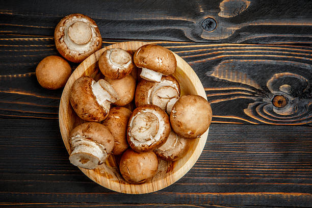 istock champignon mushroom on wooden background 616256192