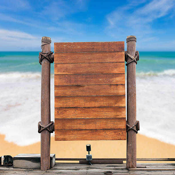 istock wooden signboard on blur beach background. 616259084
