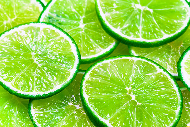 istock Green background with citrus-fruit of lime slices 616259518