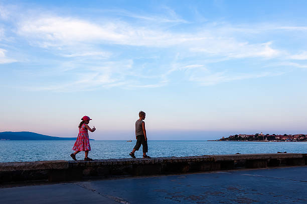Children walk along the promenade