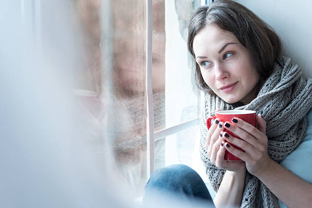istock Nice thoughtful woman looking through the window 616262360