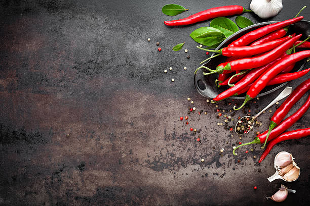 istock red hot chili pepper on dark old metal culinary background 616262588