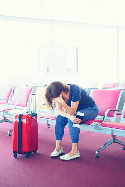 istock Distraught Woman stuck at airport 616262736