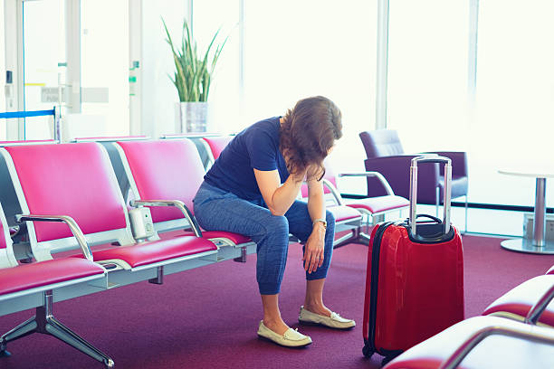 istock Distraught Woman stuck at airport 616262774