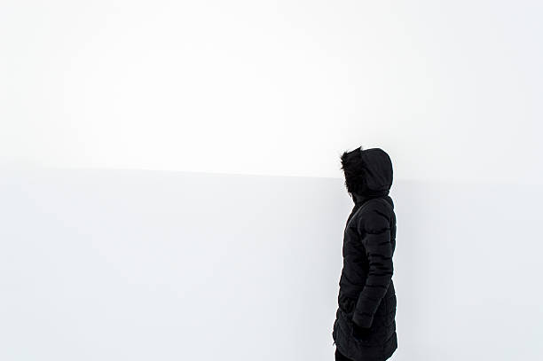 istock Woman standing in a snowy field 616263846