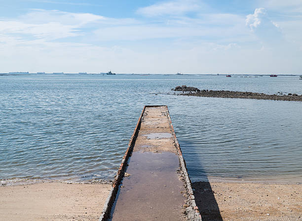 istock Stone brick jetty to the sea 616264284
