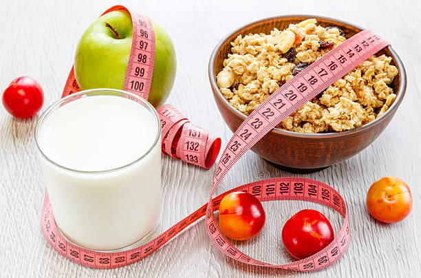 istock Muesli milk meter tape on wooden background 616854478