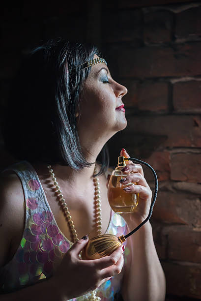 istock Beautiful woman with perfume bottle 616857966