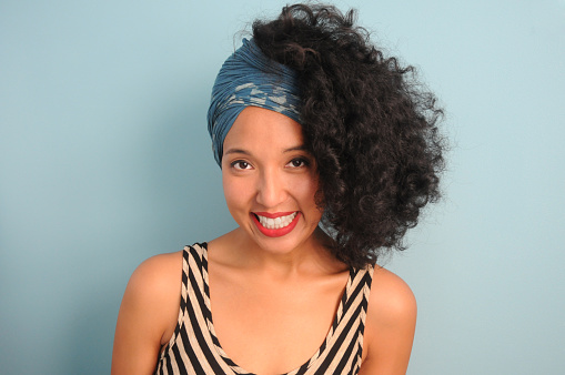 A young, mixed race woman in a headscarf.