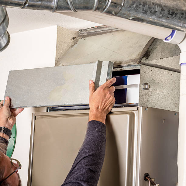 Removal of furnace access door for filter stock photo