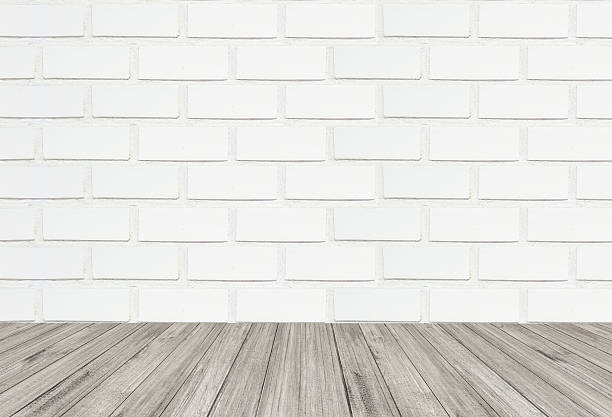 istock White brick wall texture background with wooden floor 616863792