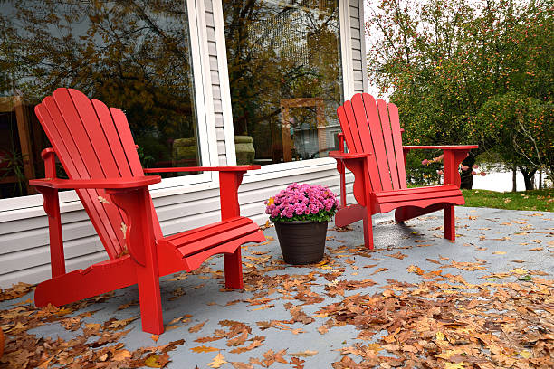 istock Red Chairs surrounded by Autumn Leaves 616864138