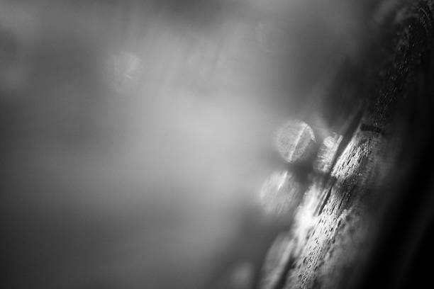 istock Car lights reflected in glass in rain 616865284