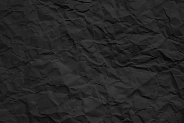Photo of crumpled dark paper texture