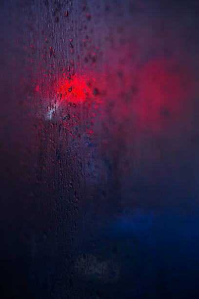 istock Traffic lights reflected in glass in rain 616865824