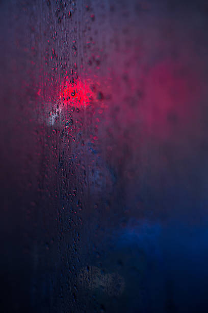 istock Traffic lights reflected in glass in rain 616866076