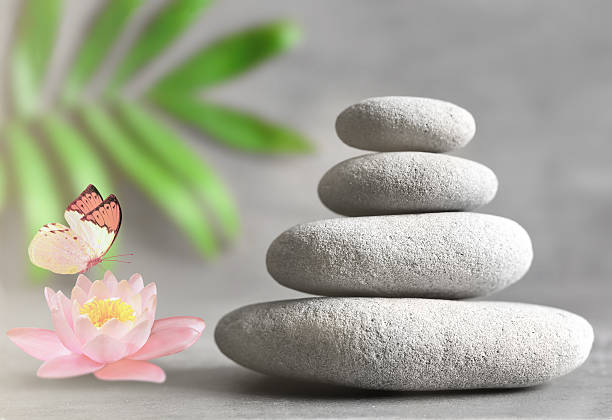 istock Spa stones with flower lily on light background 616866274
