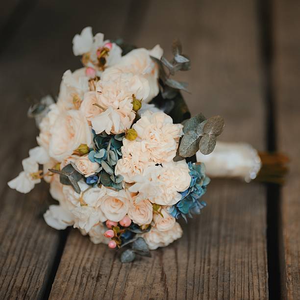 istock bouquet on wooden background, wedding accessory 616866506