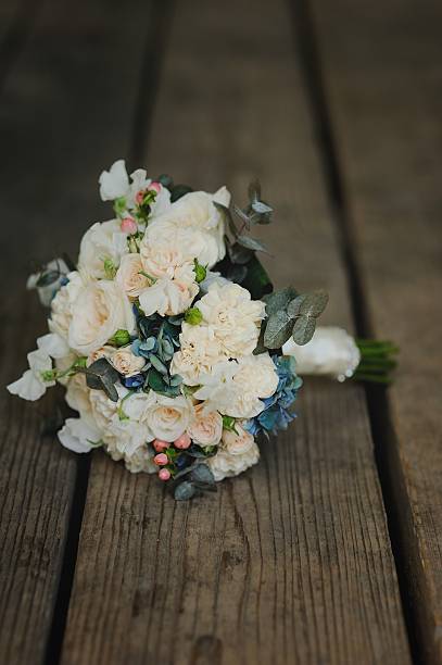istock bouquet on wooden background, wedding accessory 616866690