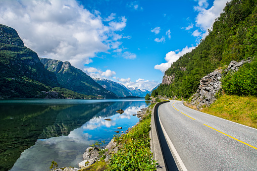 Amazing nature view with fjord and mountains. Beautiful reflection. Location: Scandinavian Mountains, Norway. Artistic picture. Beauty world. The feeling of complete freedom