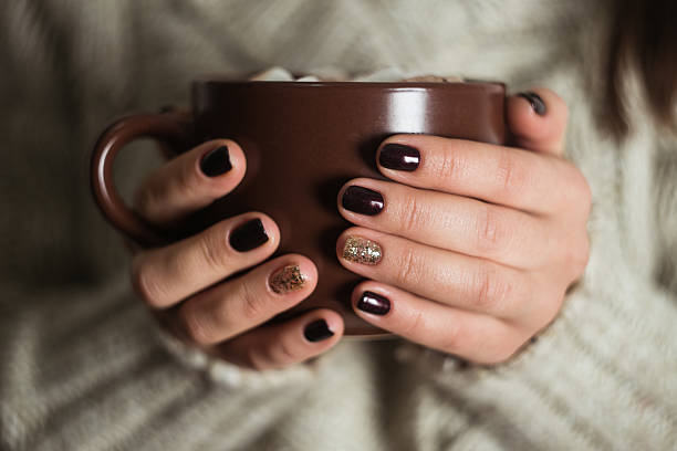 istock Brown cup with cocoa and marshmallow in the hands 616867482