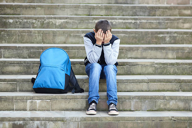 istock schoolboy crying on the street 616867486
