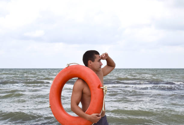 istock The man on the beach with a lifebuoy 616869128