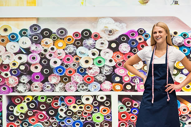 smiling seamstress posing in textile industry - silk stockings imagens e fotografias de stock