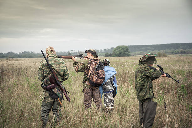 istock Hunters preparing for hunting in rural field in overcast day 616870154