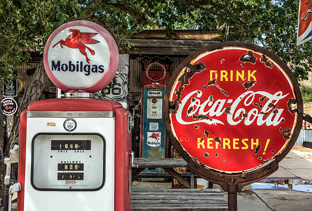 Retro gas pump and a coca-cola sign  on Route 66 Hackberry, Arizona, USA - May 19, 2016 : Retro gas pump and a rusty coca-cola sign  on historic Route 66 in Arizona route 66 sign old road stock pictures, royalty-free photos & images