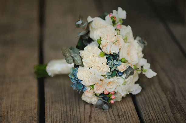 istock bouquet on wooden background, wedding accessory 616872034