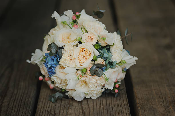 istock bouquet on wooden background, wedding accessory 616872052