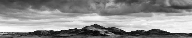 istock Panoramic view of plowed field under cloudy sky 616872366