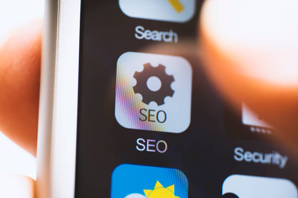 istock Hand holding phone, SEO app on screen 616874526