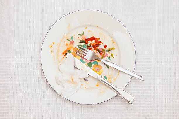 istock Leftover in porcelain plate on white tablecloth 616876662
