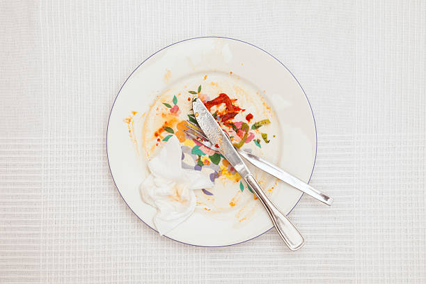 istock Leftover in porcelain plate on white tablecloth 616877220