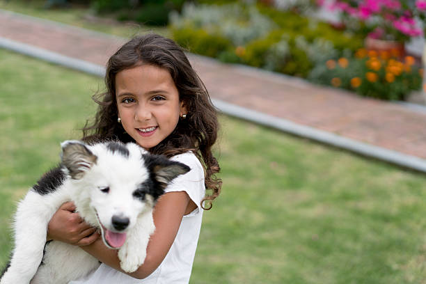 Portrait of a happy girl outdoors playing with his dog - lifestyle concepts