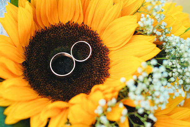 istock wedding rings lie on flower 616879220