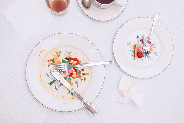 istock Leftover in porcelain plate on white tablecloth 616879696