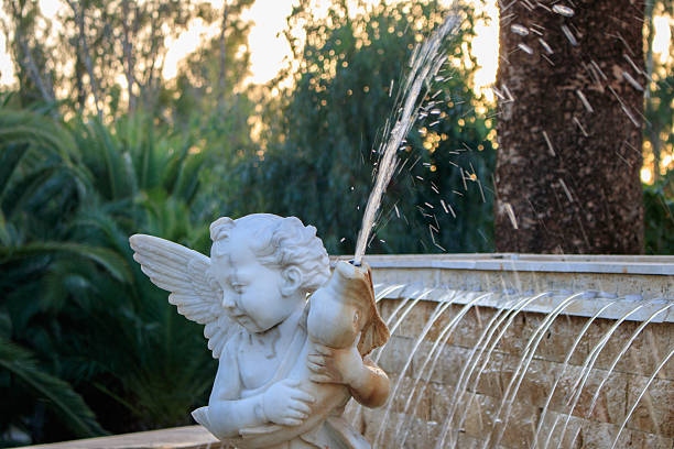 istock Angel in the fountain grab a fish 616879724